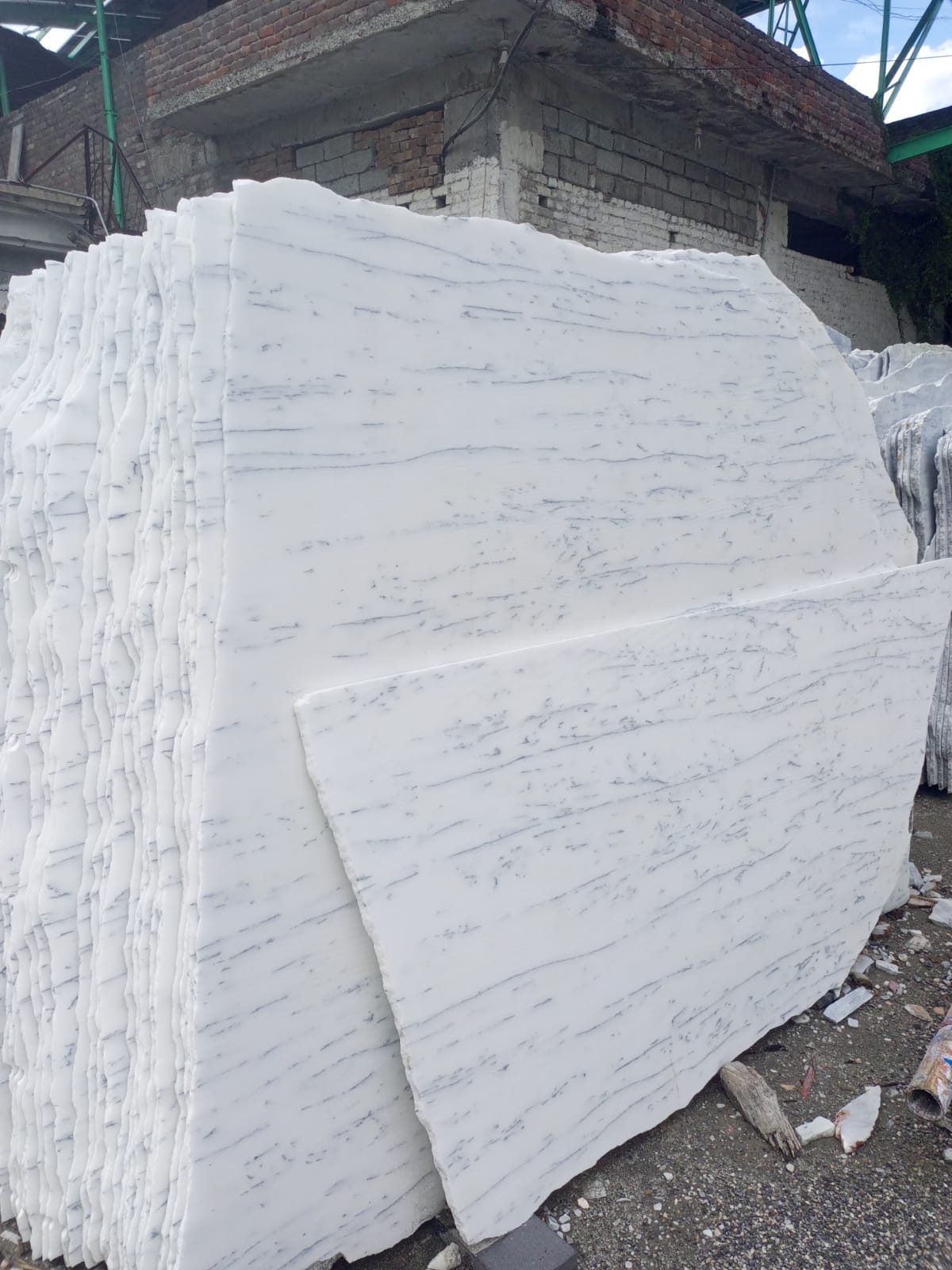 Raw marble slabs stacked at the Meezan Marble and Minerals stone yard